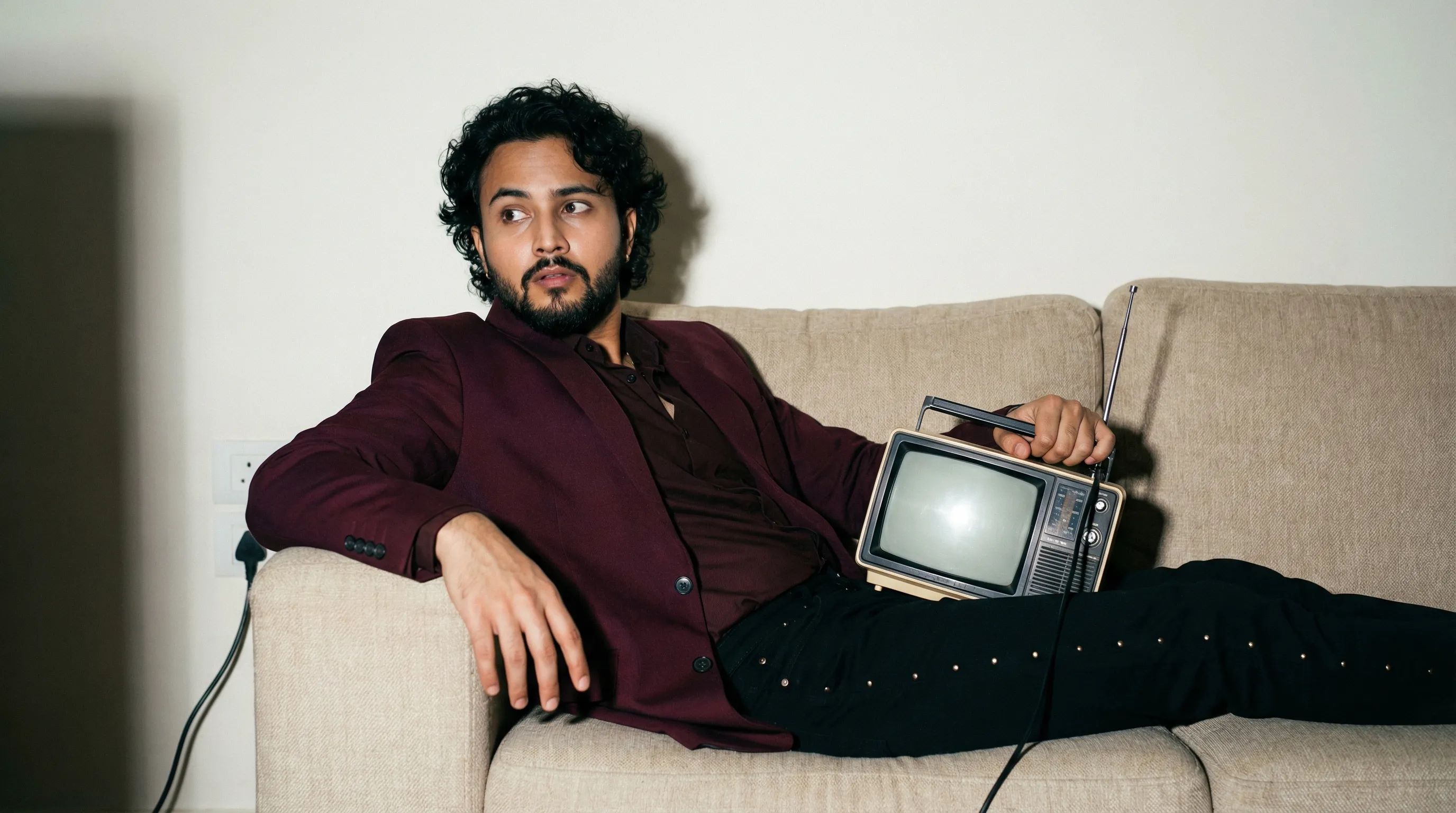 Slouching on sofa with vintage radio